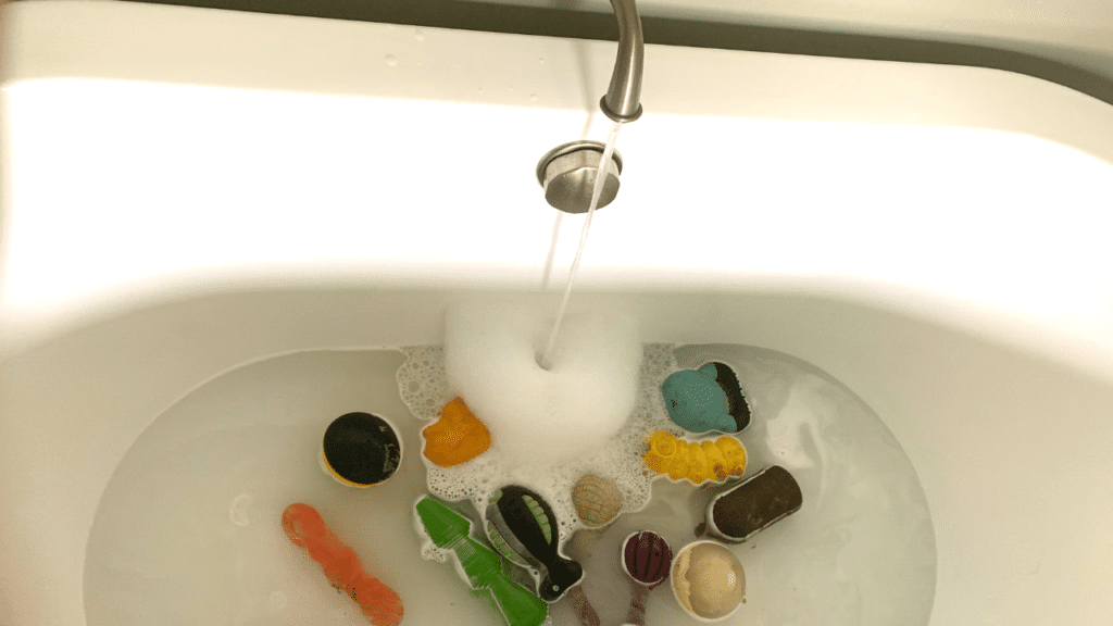 Soak dog toys in dishsoap and water